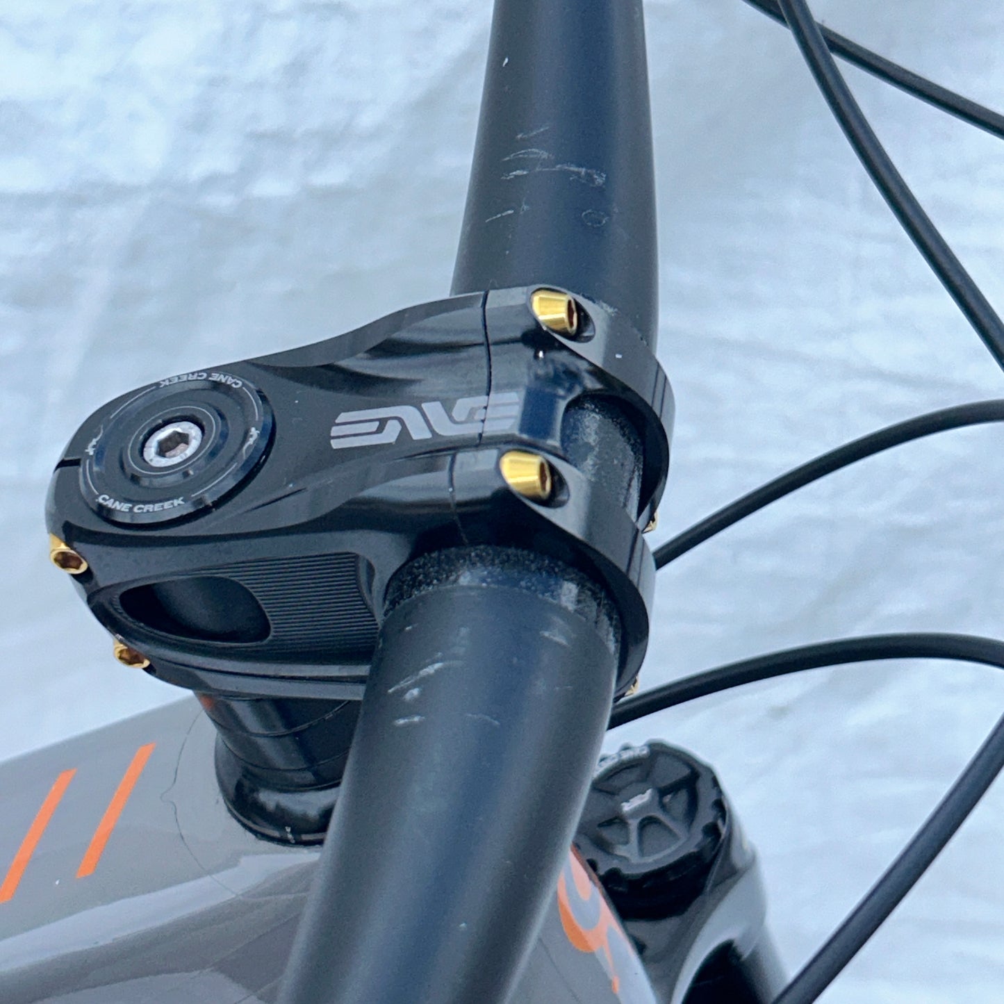 Close-up of a bicycle handlebar with ENVE logo on a blurred background